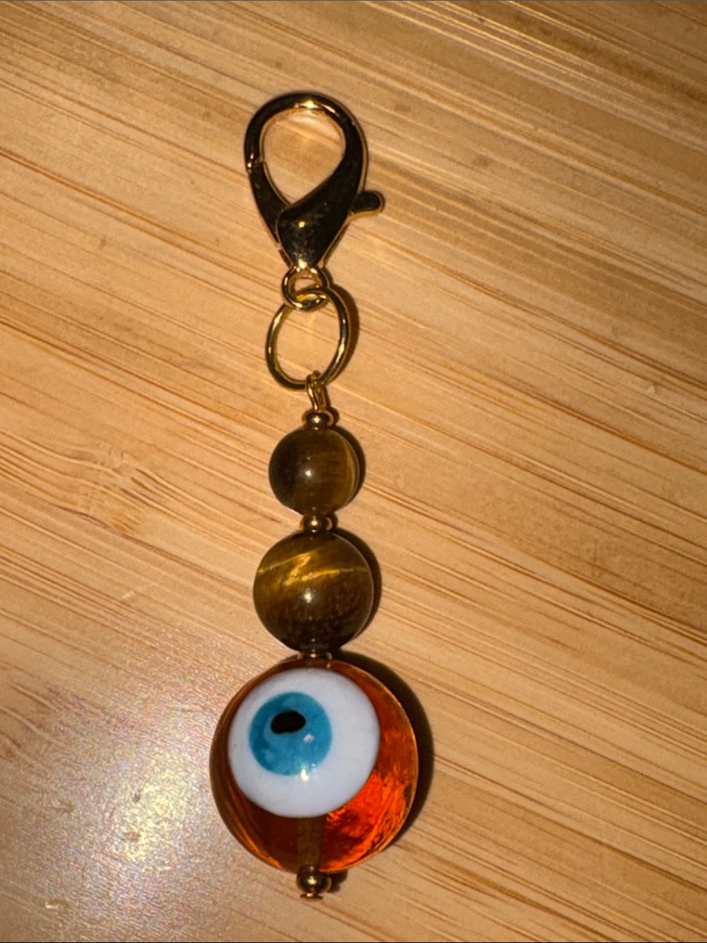 Hand Crafted Tigerโs Eye Evil Eye Glass Bead Keychain Charm in Amber & Blue